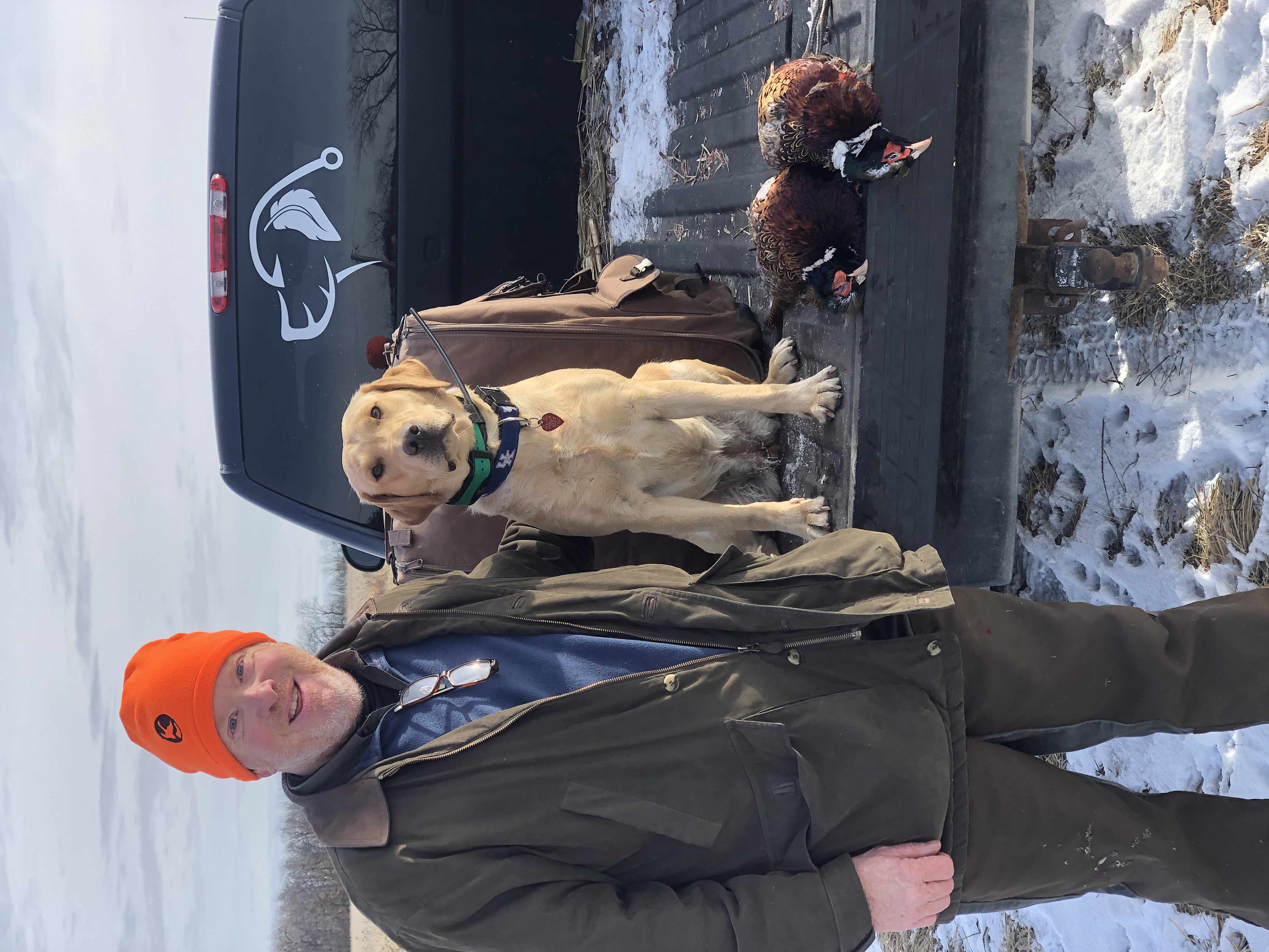 Hunter with a yellow Labrador and a pheasant harvest